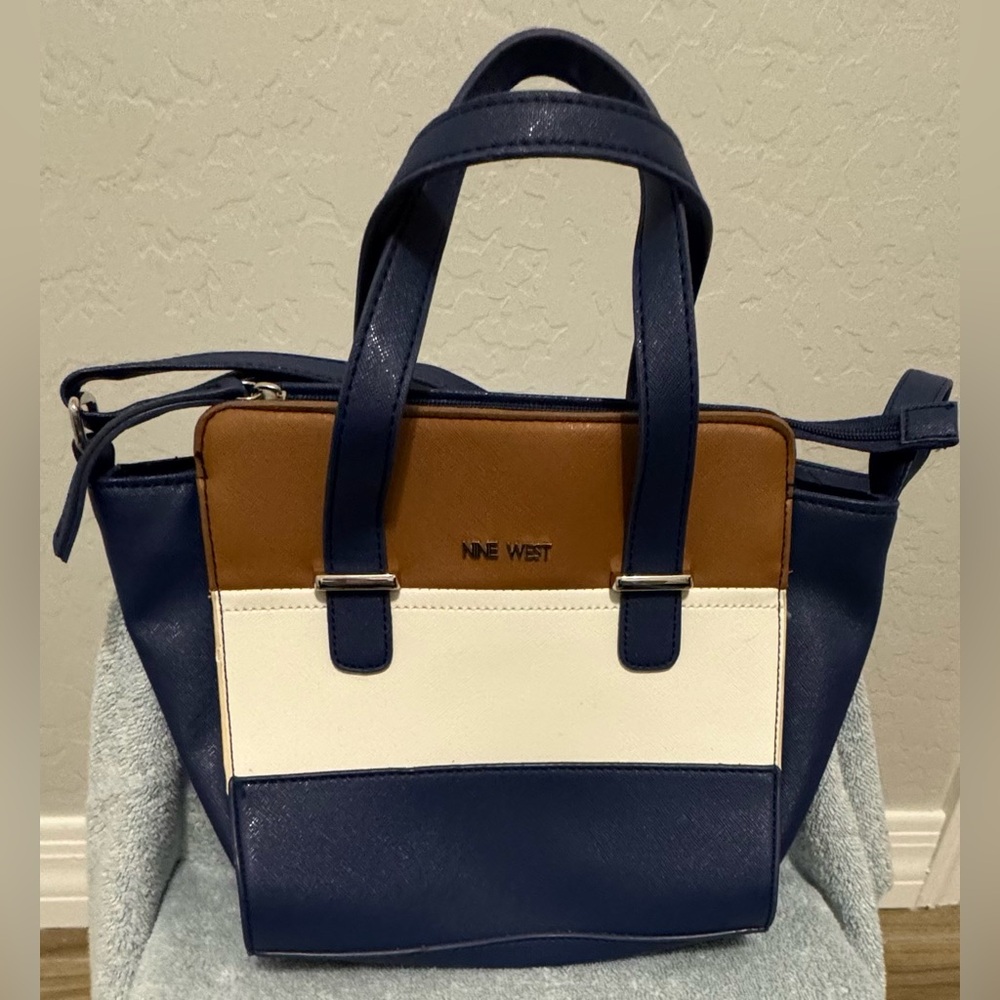 Nine West women’s blue, white and camel tan color block square satchel.